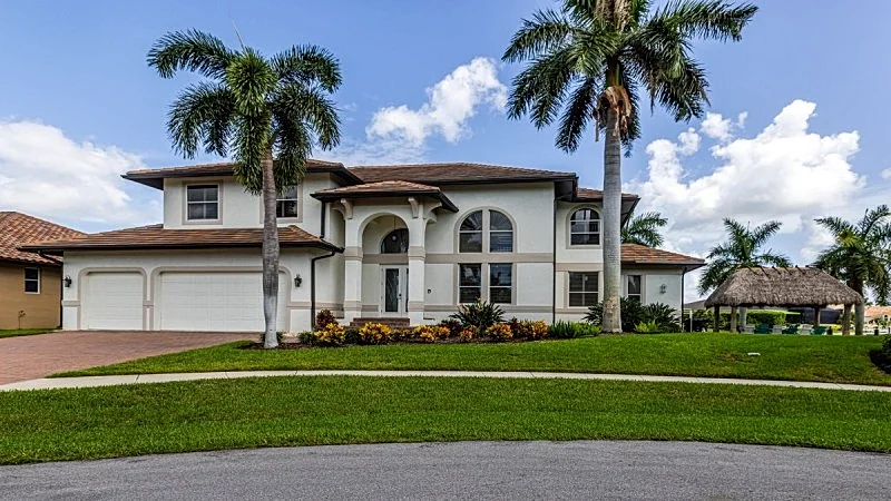 Waterfront Living at 950 Olive Ct, Elegant Two-Story Home with Pool in Marco Island