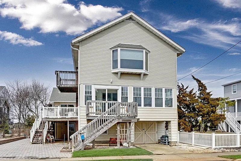 Enjoy magnificent sunsets and panoramic bay views from this unique shore home